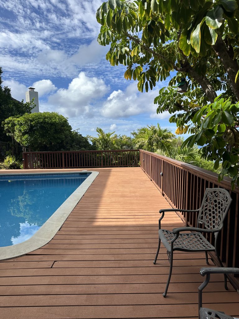 Close-up before photo of the Waialae Iki pool deck boards showing fading, cracks, and surface damage from Hawaii’s coastal conditions.
