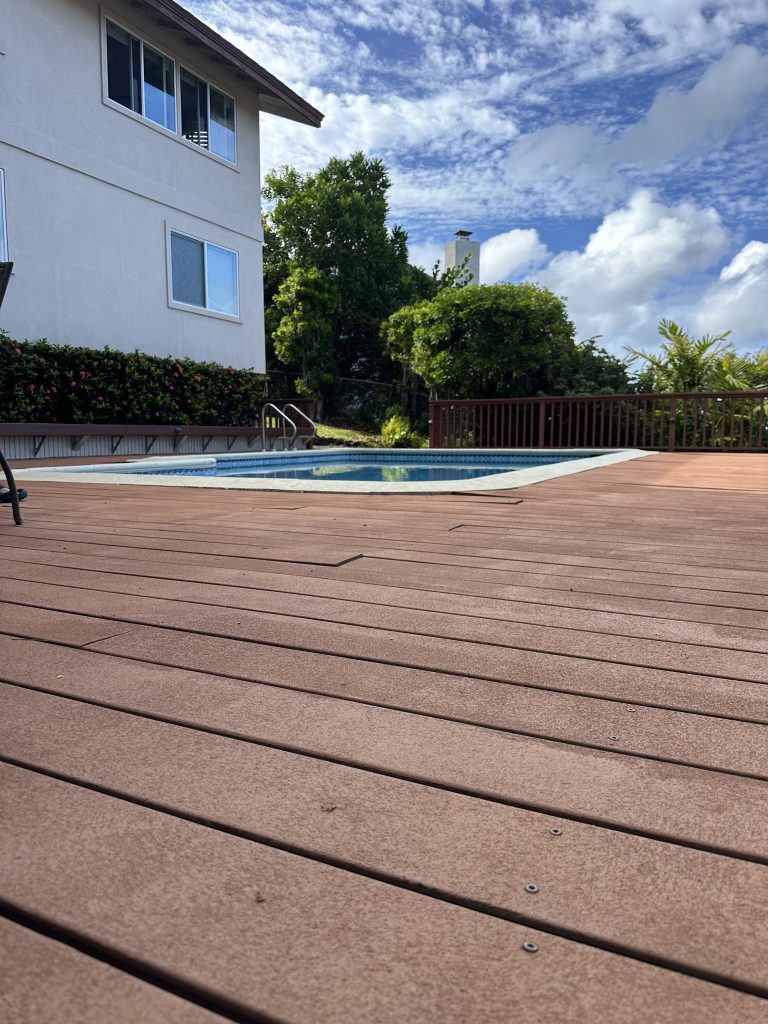 Before photo of the Waialae Iki pool deck showing deteriorated railing and weathered deck boards around the pool area.