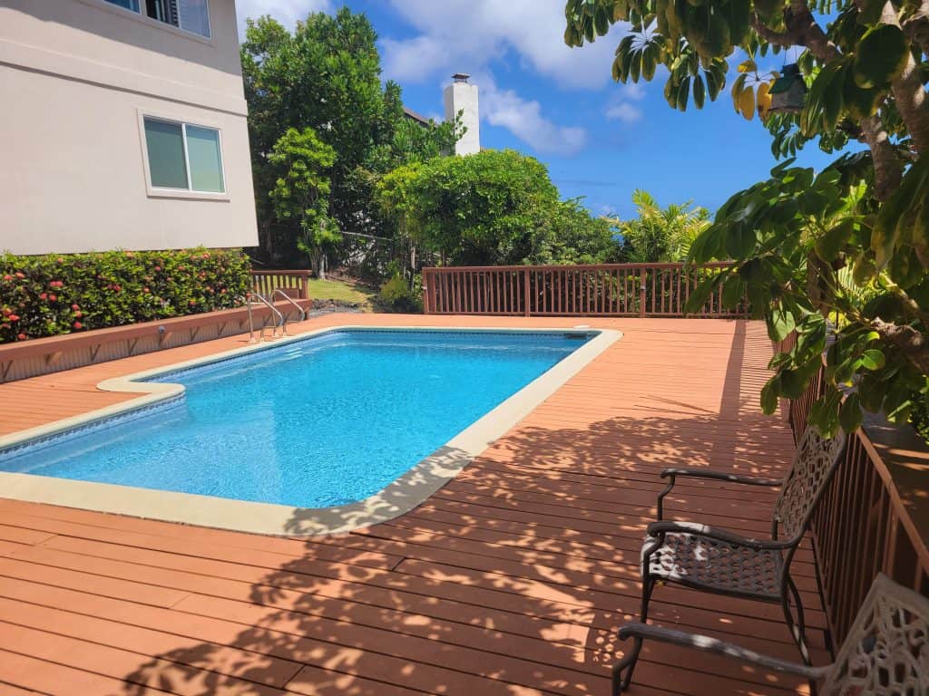 Before photo of the Waialae Iki pool deck with deteriorated composite boards and railing, documented before renovation by Hawaii Deck Builders