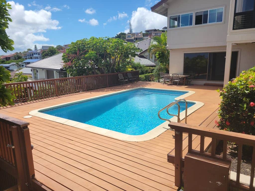 Wide-angle before photo of the Waialae Iki pool deck