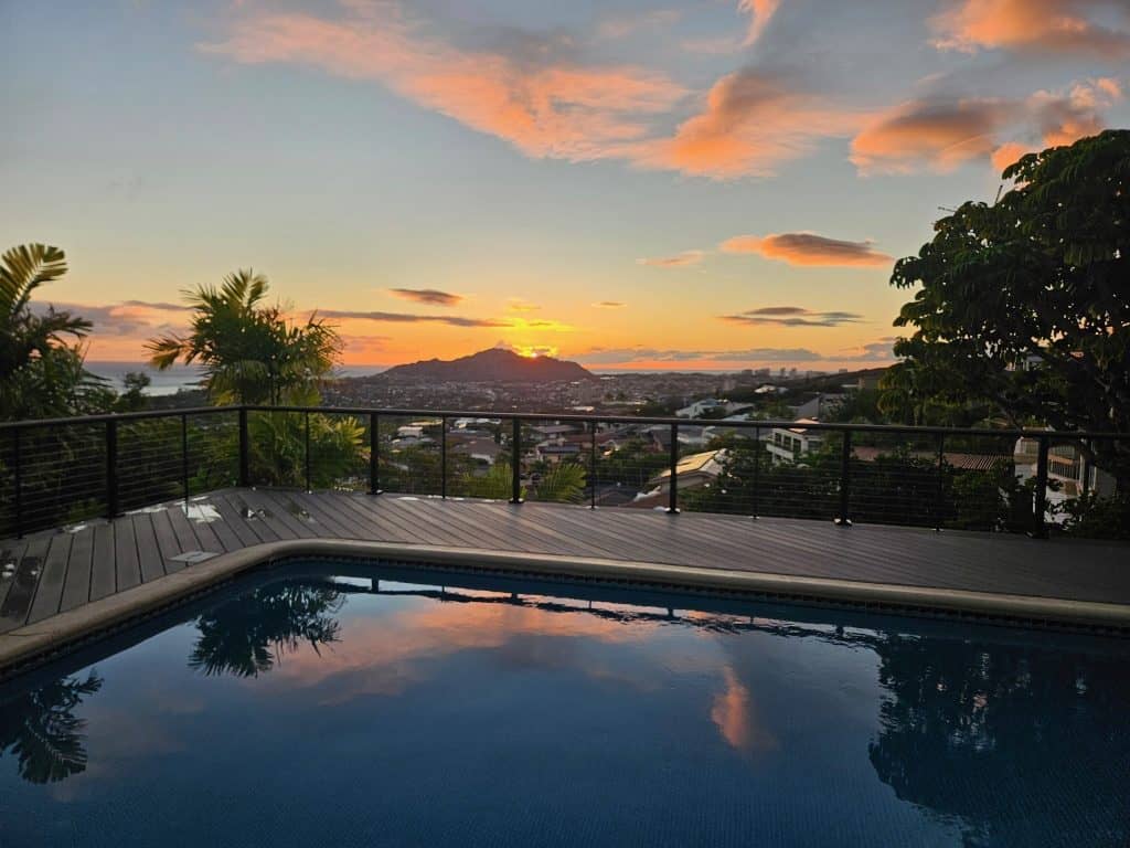 Sunset view from Waialae Iki deck remodel overlooking Honolulu with new PVC deck boards and railing