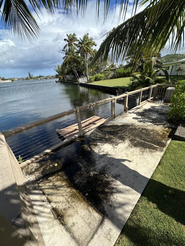 Before photo showing full view of a deteriorated waterfront deck and dock in Kailua, Oahu with extensive wood rot and aging structure — evaluated by Hawaii Deck Builders, deck safety specialists in Hawaii.