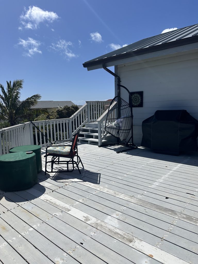 Older wood decking and railing before the Trex deck renovation in Hawaii Kai
