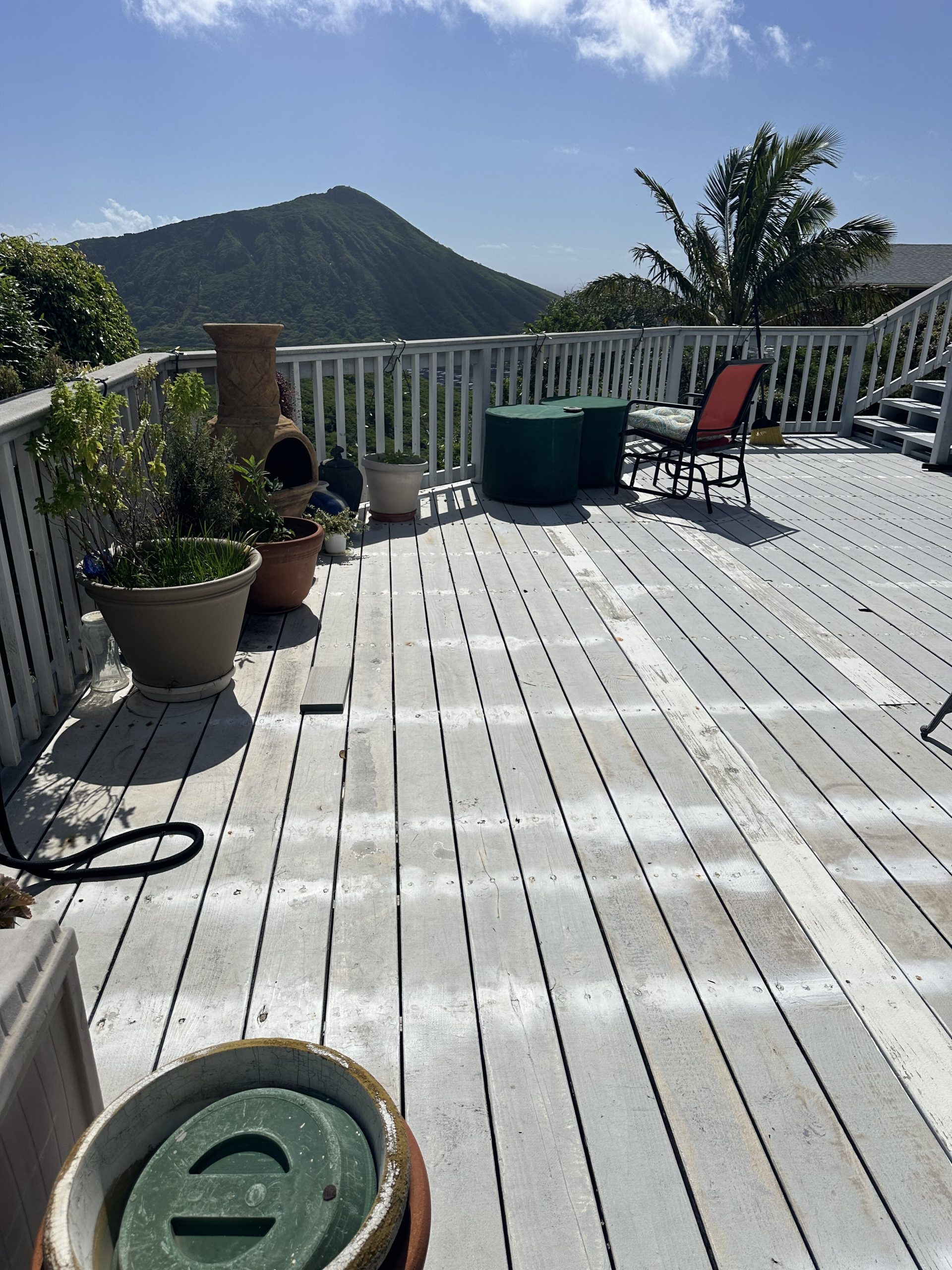 Weathered deck boards showing years of sun and weather exposure in Hawaii Kai