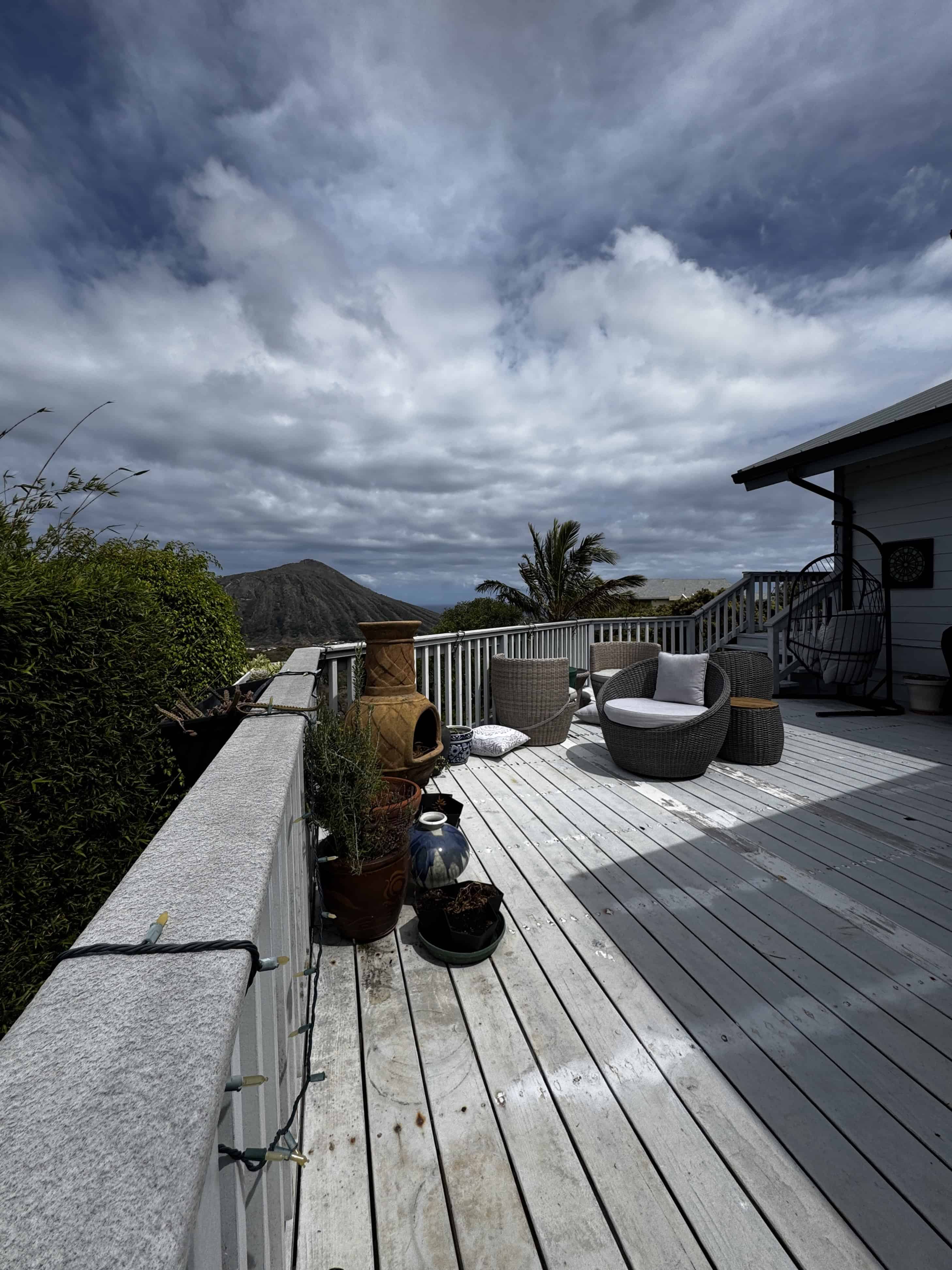 Aging deck railing and worn decking before replacement in Mariner’s Ridge